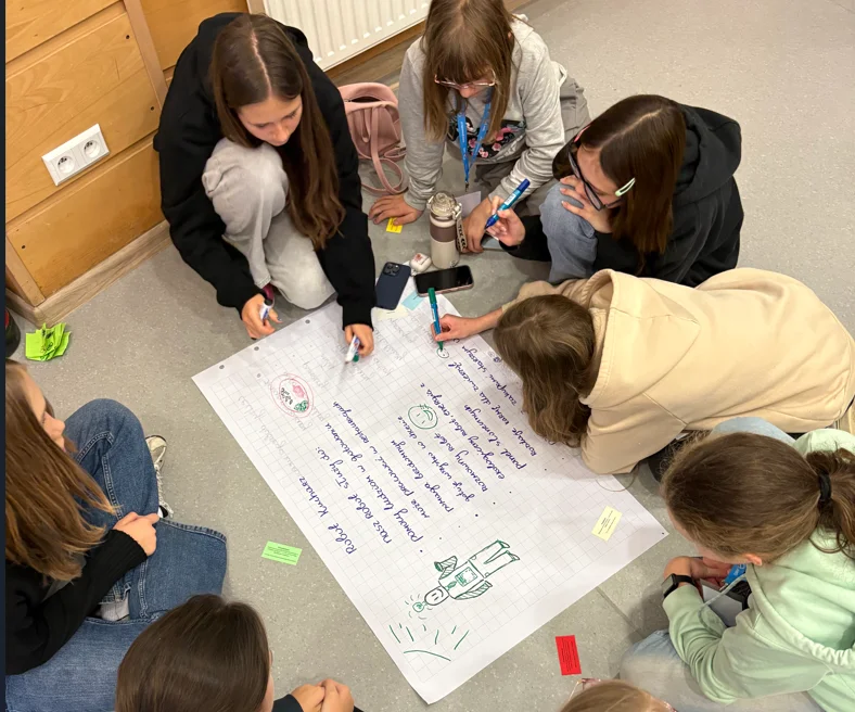Participants of the Young Economist Academy working together on a project during a class
